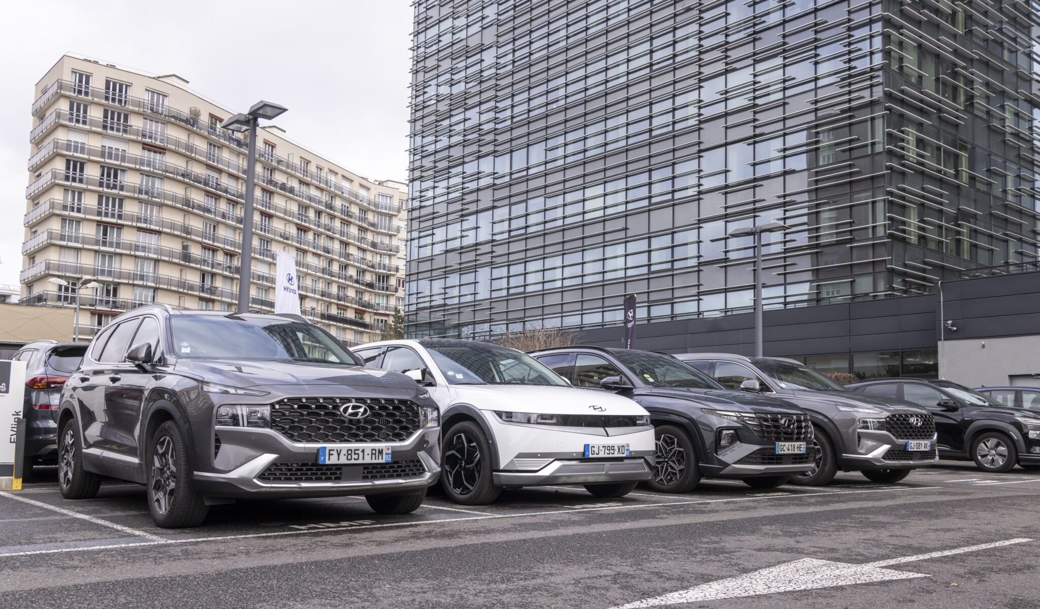 SUV Hyundai electriques et hybrides gares devant un immeuble moderne en ville pour mobilite durable